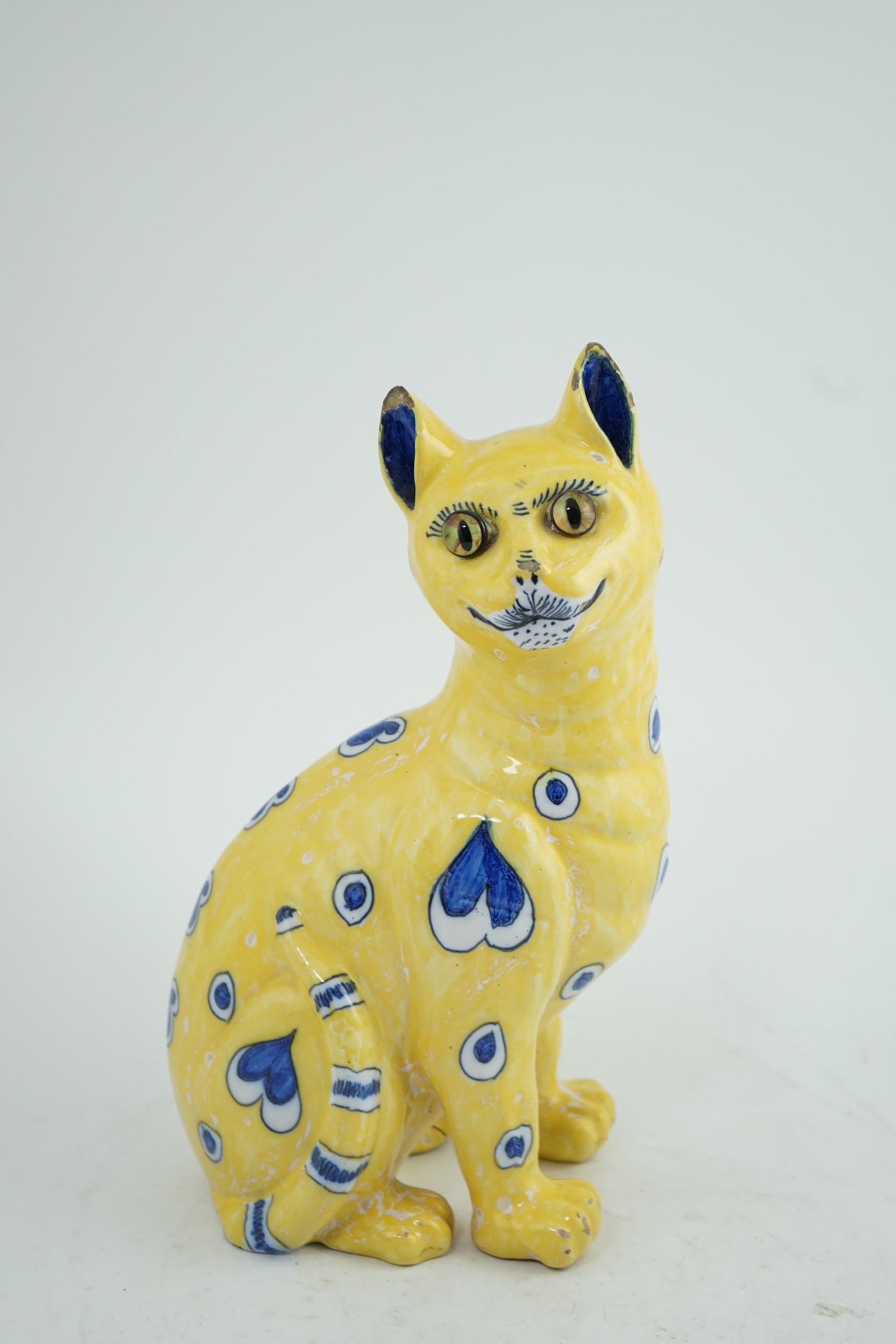 A Gallé yellow faience model of a seated smiling cat, c.1885